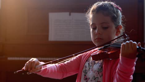 Schoolgirl-playing-violin-in-music-class-4k