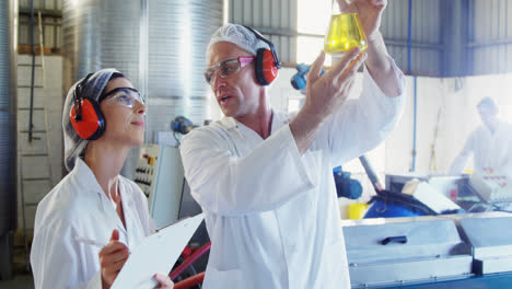 Technicians-examining-olive-oil