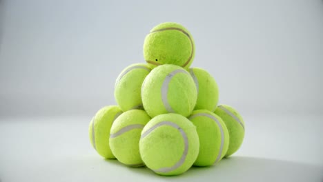 Stack-of-tennis-balls-on-white-background-4k