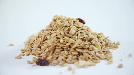 Crunchy-granola-scattered-on-white-background-4k