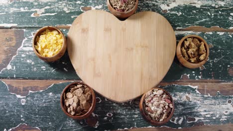 Bowl-of-various-breakfast-with-heart-shape-wooden-board-4k