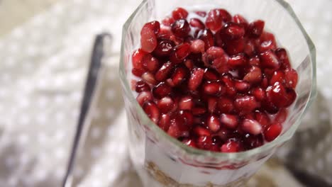 Yogurt-muesli-and-pomegranates-in-a-glass-4k