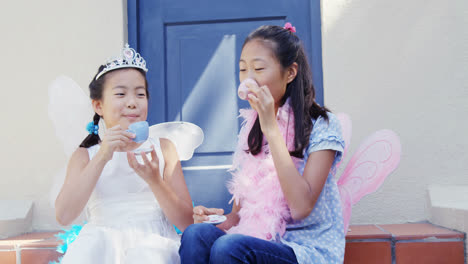 Siblings-in-fairy-costume-having-a-tea-party-4k
