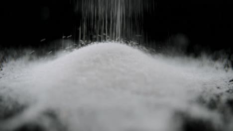 Sugar-falling-on-black-background-4k