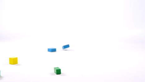 Toy-blocks-falling-on-white-background-4k