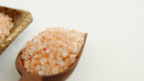 Himalayan-salt-arranged-in-wooden-bowl-and-scoop-4k