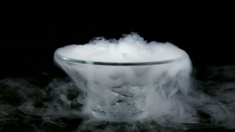 Ice-smoke-in-bowl-against-black-background-4k