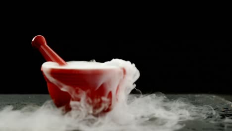 Ice-smoke-in-mortar-and-pestle-against-black-background-4k