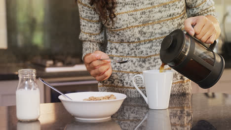 Happy-woman-wearing-winter-cloths-pouring-coffee-in-coffee-mug-4K-4k