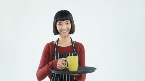 Smiling-waitress-holding-a-tray-of-coffee-cup-against-white-background-4K-4k