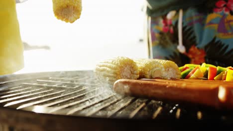 Preparing-corn-and-hotdog-on-barbecue-at-the-beach-4k