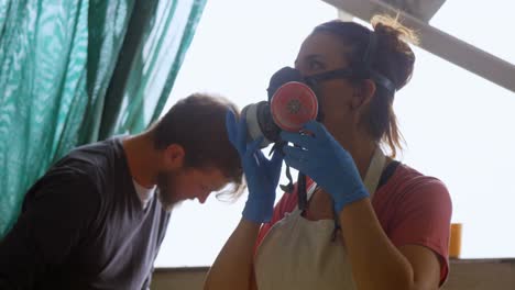 Woman-wearing-gas-mask-in-workshop-4k