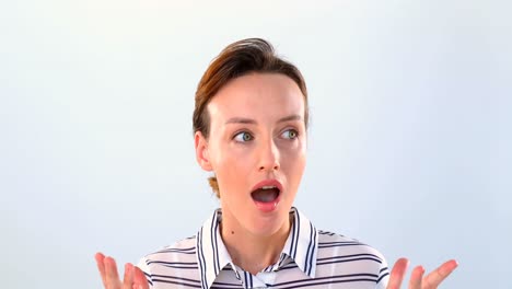 Shocked-woman-standing-against-white-background-4k