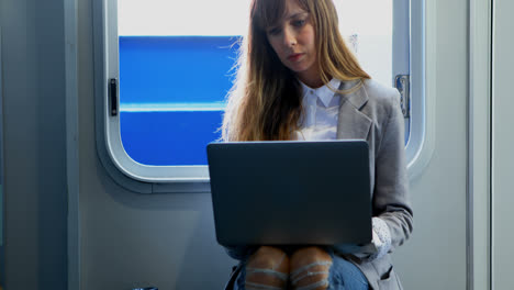 Woman-using-laptop-while-travelling-in-ferry-4k