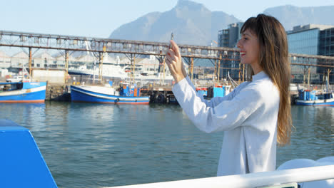Woman-taking-photo-with-mobile-phone-while-travelling-in-ferry-4k-