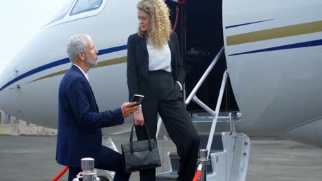 Business-people-interacting-with-each-other-at-the-entrance-of-private-jet-4k