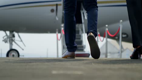Business-people-walking-towards-private-jet-4k