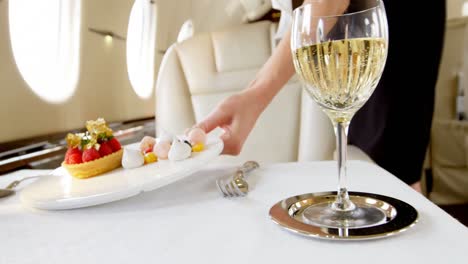 Flight-attendant-serving-sweet-food-in-private-jet-4k