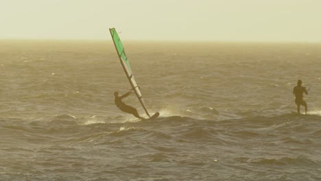 Male-surfers-windsurfing-in-the-beach-4k