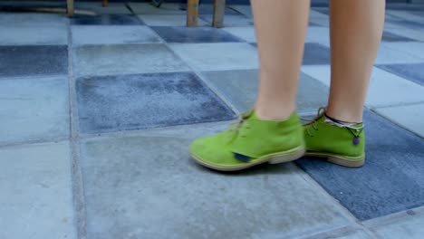 Woman-with-green-shoes-walking-on-tiled-floor-4k