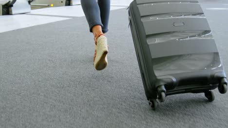 Businesswoman-walking-with-suitcase-in-office-4k