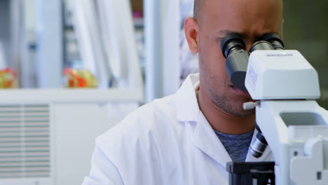 Scientist-looking-through-microscope-4k