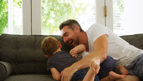 Father-and-kids-having-fun-on-sofa-4k