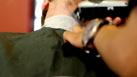 Man-getting-his-beard-trimmed-with-trimmer-4k