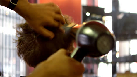 Barber-using-hair-dryer-machine-on-mans-hair-4k