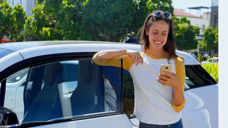 Woman-using-mobile-phone-near-her-car-4k