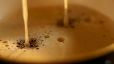 Fresh-coffee-drops-falling-to-coffee-cup-4k