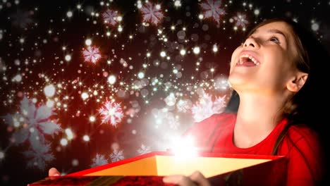 Aufgeregtes-Mädchen-öffnet-Magische-Weihnachtsgeschenkbox-Mit-Funkelnden-Schneeflocken