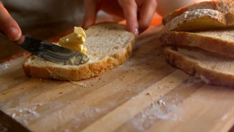 Woman-applying-butter-on-bread-4k