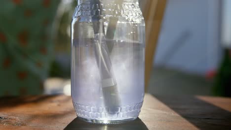 Washing-drawing-brush-in-a-glass-jar-4k