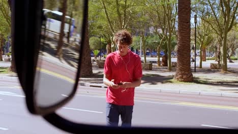 Man-using-mobile-phone-on-city-street-4k