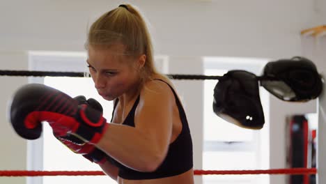 Female-boxer-practicing-boxing-in-a-boxing-ring-4k