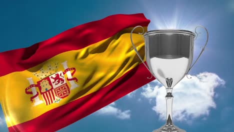 Spanish-Flag-and-trophy-with-blue-sky-and-sunshine-background