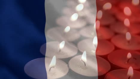 French-flag-with-candles-being-blown-out-in-the-background