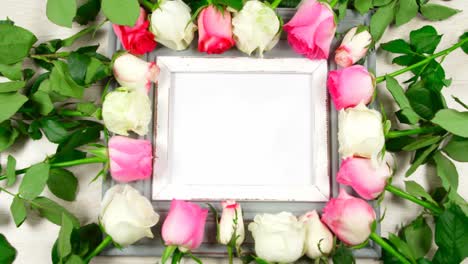 Blank-photo-frame-surrounded-with-roses-4k