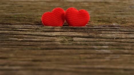 Two-red-hearts-tuck-on-the-wooden-plank-4k