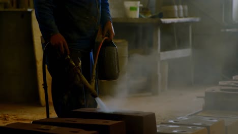 Male-water-spraying-water-on-heated-molds-in-workshop-4k