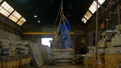 Worker-using-overhead-crane-in-foundry-workshop-4k