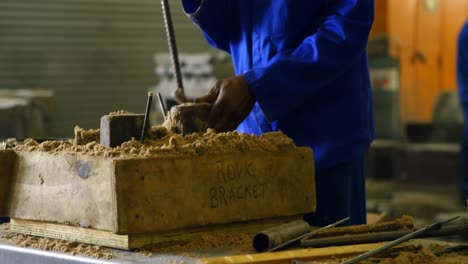 Worker-putting-soil-in-wooden-mold-in-workshop-4k