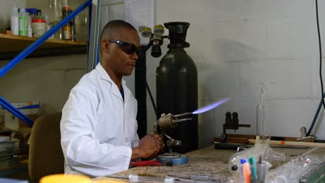 Worker-using-welding-torch-in-glass-factory-4k