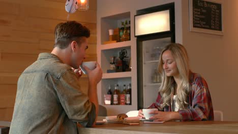 Young-couple-interacting-with-each-other-in-cafe-4k