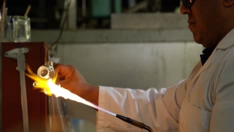 Side-view-of-male-worker-creating-ng-glass-in-glass-factory-4k