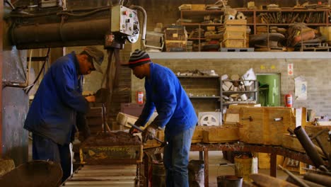 Workers-putting-soil-in-mold-in-foundry-workshop-4k
