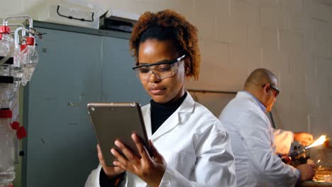 Female-worker-using-digital-tablet-in-glass-factory-4k
