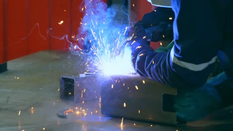 Robotic-engineer-welding-metal-in-robotic-warehouse-4k