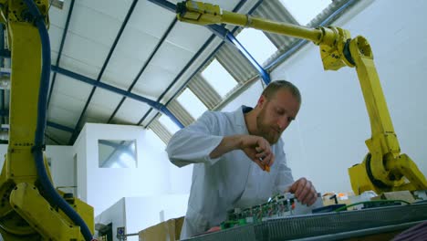 Robotic-engineer-repairing-circuit-board-at-table-4k